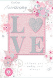 The scene captures a gentle, romantic anniversary card whose design blends soft pastel pinks, warm whites, and silvery greys to create an atmosphere of treasured intimacy, reminiscent of a calm evening at home in Cranham. At the centre, the word LOVE appears in raised, velvety glitter, the texture suggesting a soft yet defined feel beneath the fingers. The letter O is transformed into a shimmering heart filled with textured silver, becoming the emotional focal point of the piece, like a tiny emblem of the years shared. Around this glimmering centrepiece, delicate blossoms in blush and mauve unfurl with a watercolour softness, their edges traced in fine lines that give them a sense of openness and air. Slender stems and swirling vines curl outward from the central motif, interspersed with tiny butterflies, petals, and flourishes that lend an impression of gentle movement - as if a light spring breeze were passing through a garden near Cranham's playing fields. The background remains a calm, pale pink, allowing the flowers and glittering heart to stand clearly in view while maintaining a soothing overall tone. Above or near the central motif, the phrase On Our Anniversary is written in a graceful, understated script, complemented by the heartfelt promise I love you today and always, placed where it can be read easily without disturbing the artwork's flow. The lighting is soft and even, allowing every textured highlight and silver accent to be seen without overwhelming the eyes. Altogether, the card exudes a quiet, heartfelt warmth, like a paper companion to an anniversary bouquet delivered to a Cranham doorstep, marking a shared journey that is both tender and enduring.